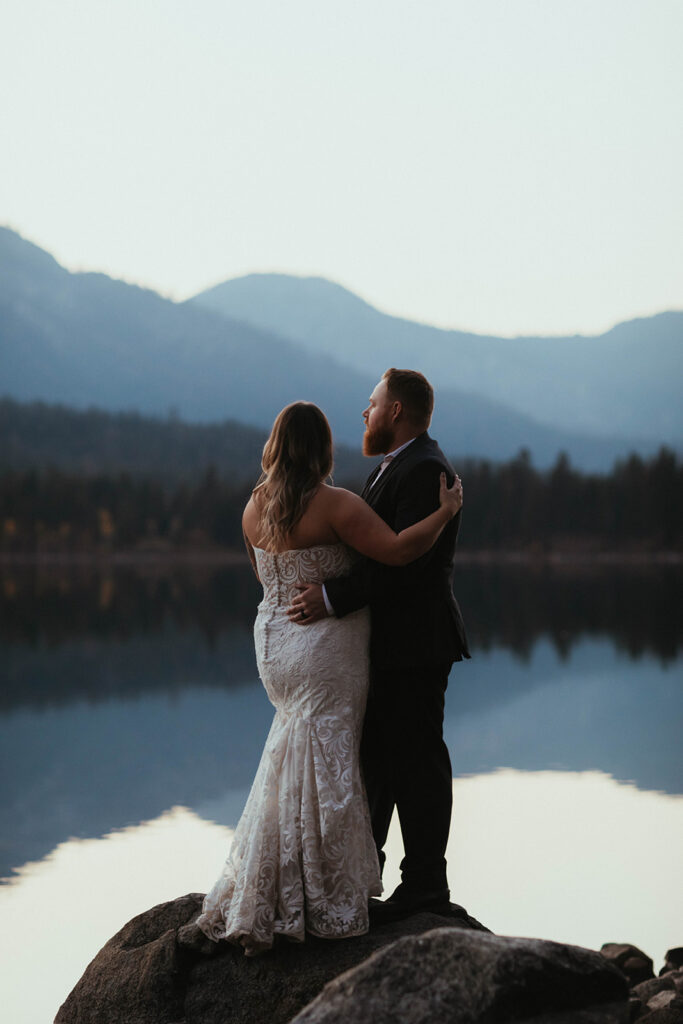 Man and woman in white dress say wedding vows overlooking Fallen Leaf Lake Nevada