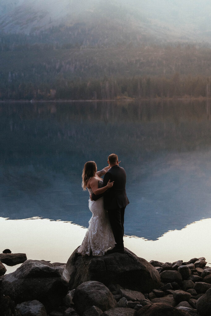 Man and woman in white dress say wedding vows overlooking Fallen Leaf Lake Nevada