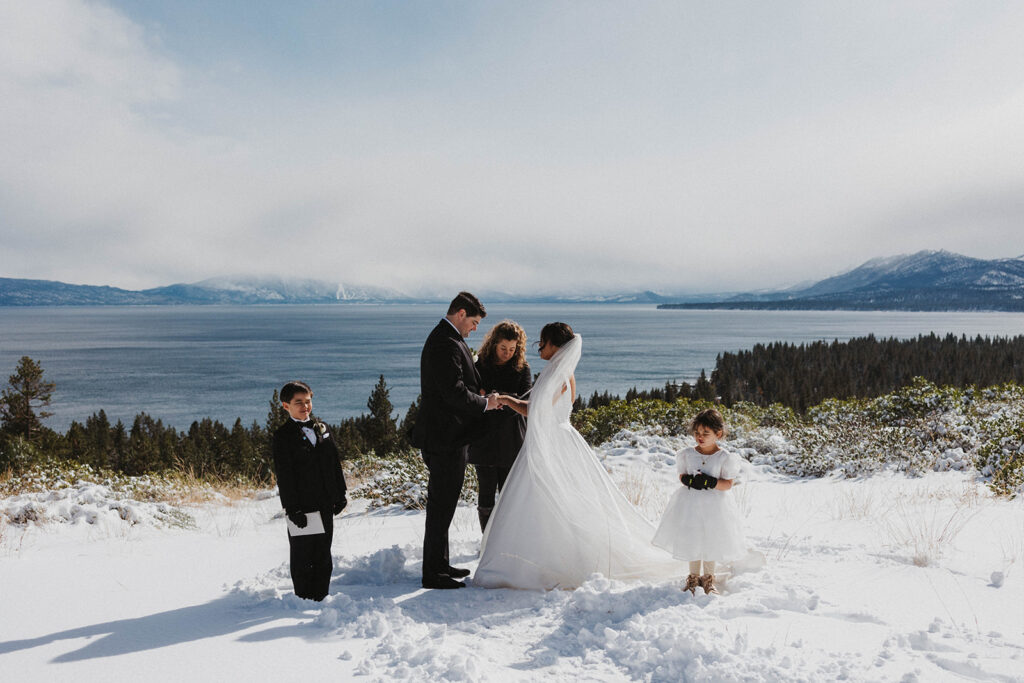 Husband and wife in white wedding dress say vows with views of Lake Tahoe Nevada